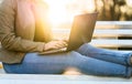 Woman using laptop in sunset outdoors Royalty Free Stock Photo