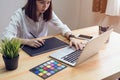 Woman using laptop on table in office room, for graphics display montage. Royalty Free Stock Photo