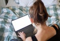 woman using laptop or tablet in bed white empty screen for copy space Royalty Free Stock Photo