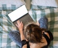 Woman using laptop or tablet in bed white empty screen for copy space Royalty Free Stock Photo