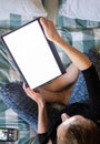 Woman using laptop or tablet in bed white empty screen for copy space Royalty Free Stock Photo
