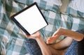 Woman using laptop or tablet in bed white empty screen for copy space Royalty Free Stock Photo