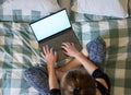 Woman using laptop or tablet in bed white empty screen for copy space Royalty Free Stock Photo
