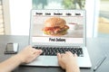 Woman using laptop to order food delivery Royalty Free Stock Photo