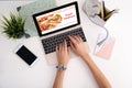 Woman using laptop to order food delivery at table Royalty Free Stock Photo