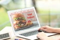 Woman using laptop to order food delivery Royalty Free Stock Photo