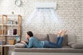 Woman Using Laptop Under The Air Conditioner Royalty Free Stock Photo