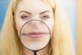 Woman using magnifer on her lips