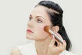 Woman using makeup brush for blush Royalty Free Stock Photo