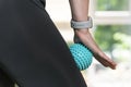 Woman using massage tool for myofascial therapy on thigh muscles. Roller for physiotherapy