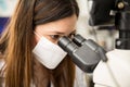 Woman using microscope in a lab Royalty Free Stock Photo