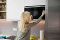 Woman Using Microwave Oven For Heating Food Royalty Free Stock Photo