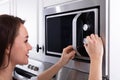 Woman Using Microwave Oven Royalty Free Stock Photo