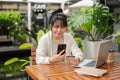 A woman is using a mobile banking app on her smartphone, paying bills online or buying online stuff Royalty Free Stock Photo