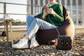 Woman using mobile due to portable charging station outdoors