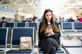 Young woman using mobile phone at airport Royalty Free Stock Photo