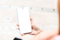 Woman using mobile phone with empty white screen, mockup for your app design.Mobile app mockup.Woman showing smartphone with blank Royalty Free Stock Photo