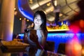 Woman using mobile phone and enjoy her drink at sky bar Royalty Free Stock Photo