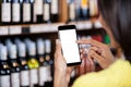 Woman using mobile phone in grocery section Royalty Free Stock Photo