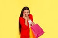 Woman using mobile phone and holding shopping bags Royalty Free Stock Photo