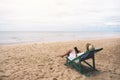 A woman using mobile phone while laying down on a beach chair Royalty Free Stock Photo