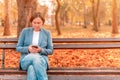 Woman using mobile phone on rest break during work hours Royalty Free Stock Photo