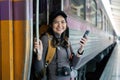 Woman using mobile phone while travel by train. travel concept Royalty Free Stock Photo