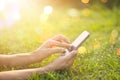 Woman using mobile smart phone outdoor in the sunrise on nature Royalty Free Stock Photo