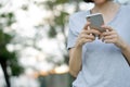 Woman using mobile smart phone in the park