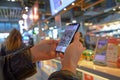 Woman using mobile smart phone in shopping mall with qr code on screen Royalty Free Stock Photo