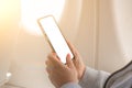 Woman using mockup smartphone on airplane. woman`s hands holding a black smart phone with blank desktop screen next in the cabin Royalty Free Stock Photo