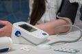 woman using modern blood pressure monitor at home. woman measuring blood pressure during self-examination