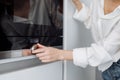 Woman using modern microwave oven at home