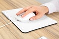 Woman using modern wired optical mouse at table, closeup Royalty Free Stock Photo