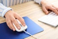 Woman using modern wired optical mouse at office table Royalty Free Stock Photo