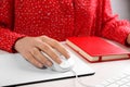 Woman using modern wired optical mouse at office table Royalty Free Stock Photo