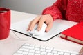 Woman using modern wired optical mouse at office table Royalty Free Stock Photo