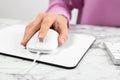 Woman using modern wired optical mouse at office table Royalty Free Stock Photo