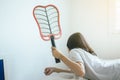 Woman using mosquito swatter at house,Female with mosquito electric net racket in bedroom Royalty Free Stock Photo