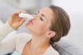 Woman using nasal drops Royalty Free Stock Photo