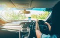 Woman using navigation app on smartphone while driving a car Royalty Free Stock Photo