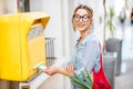 Woman using old mailbox outdoors Royalty Free Stock Photo