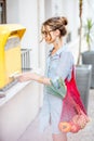 Woman using old mailbox outdoors Royalty Free Stock Photo