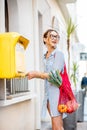 Woman using old mailbox outdoors Royalty Free Stock Photo