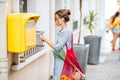 Woman using old mailbox outdoors Royalty Free Stock Photo