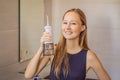 Woman using an oral irrigator in bathroom Royalty Free Stock Photo