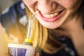 A woman using an oral irrigator in bathroom. Selective focus