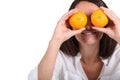 Woman using oranges for eyes