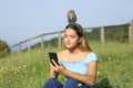 Woman using phone with a bird on head Royalty Free Stock Photo