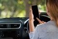 Woman using phone in car on road Royalty Free Stock Photo